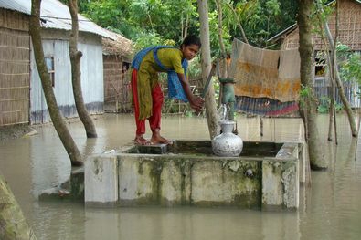 Woman using flood resilient tube well in Bangladesh